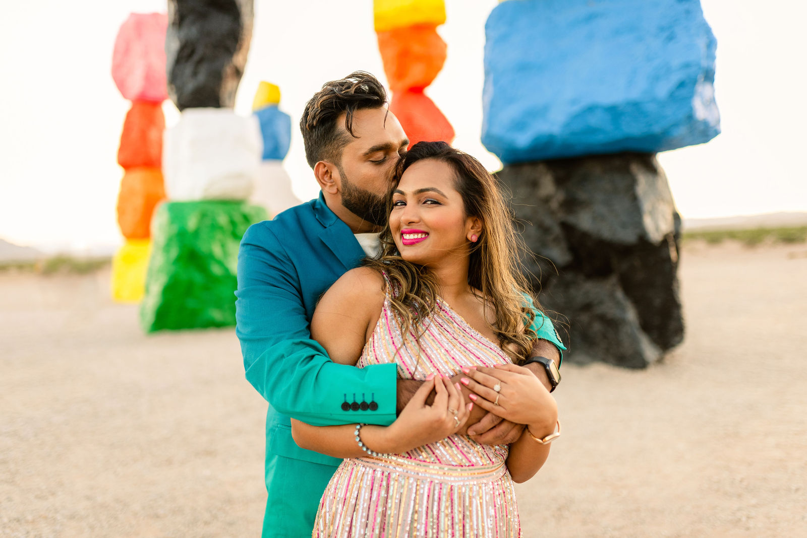 Couple embracing at Seven Magic Mountains art installation