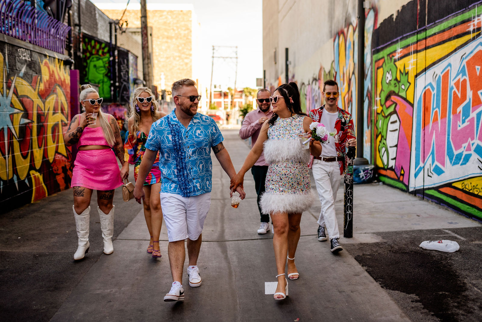 Wedding party walking through Las Vegas arts district graffiti alley