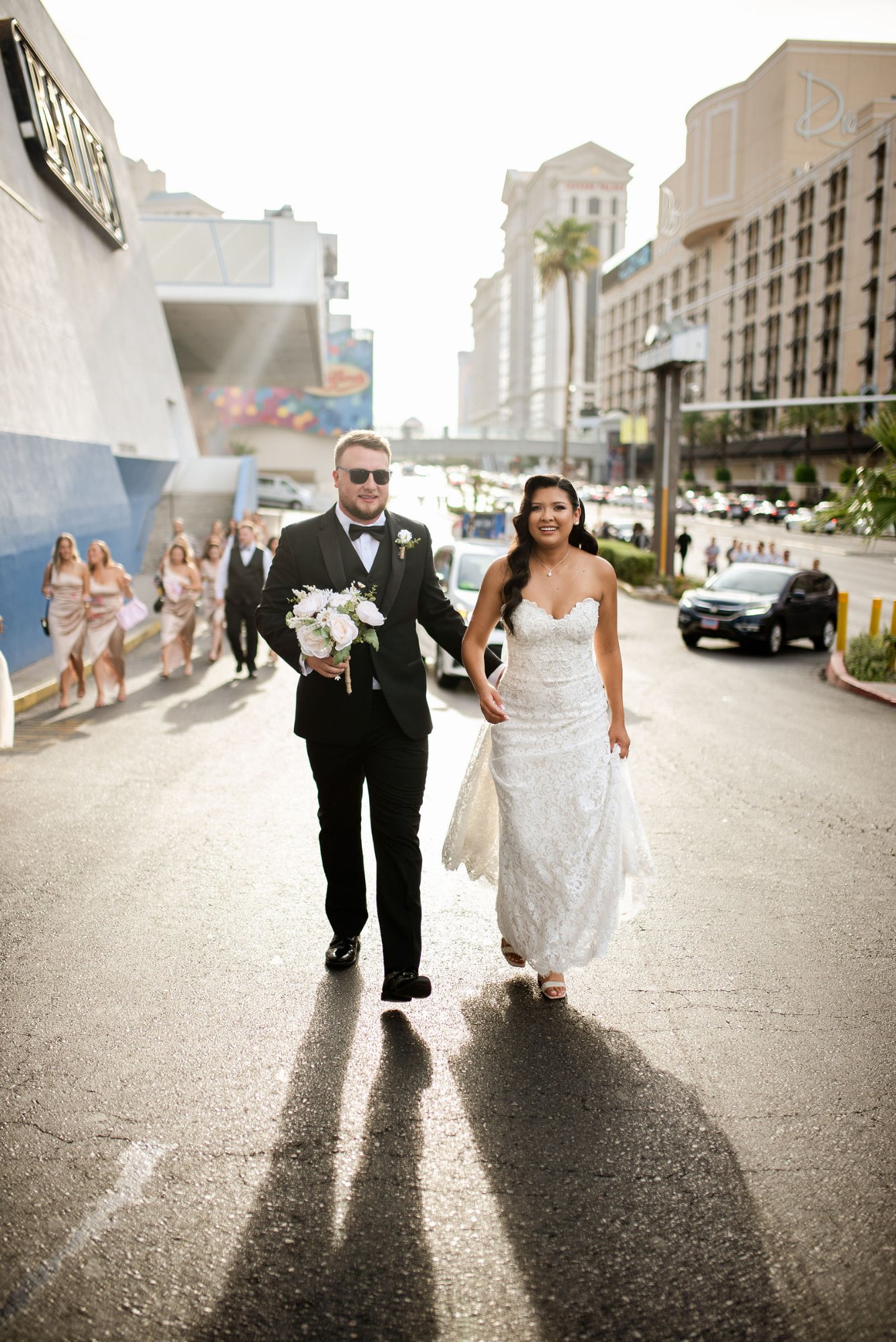 Bride and groom walking on the Las Vegas Strip with wedding party